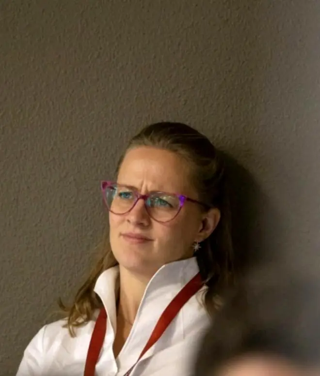 Gabi listening, lanyard round her neck