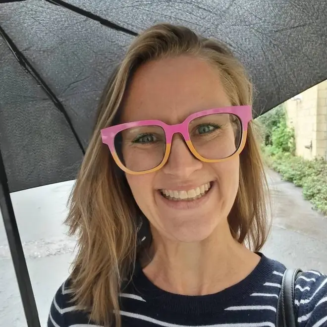 Gabi outdoors under an umbrella
